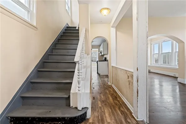 a view of entryway and hall with wooden floor