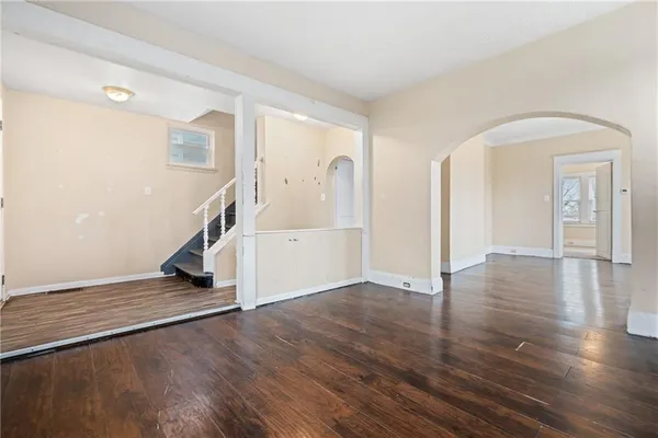 a view of a room with wooden floor and stairs