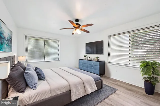 a bedroom with a bed and a potted plant