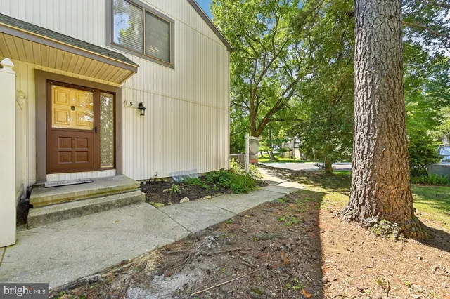 a pathway of a house with a yard
