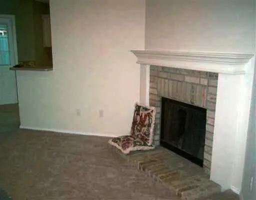 a room with a fireplace and a mirror