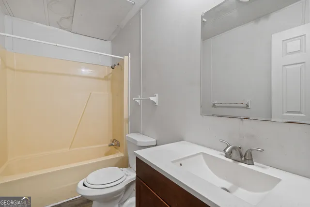 a bathroom with a sink toilet tub and shower