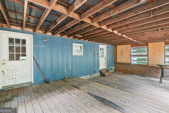 a bedroom with a bed and wooden floors
