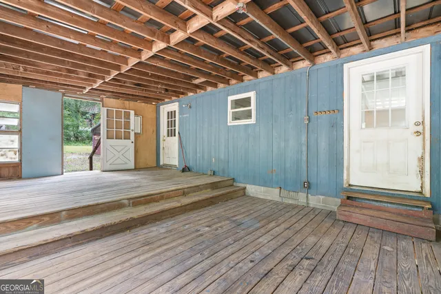 a view of a backyard with plants and wooden fence