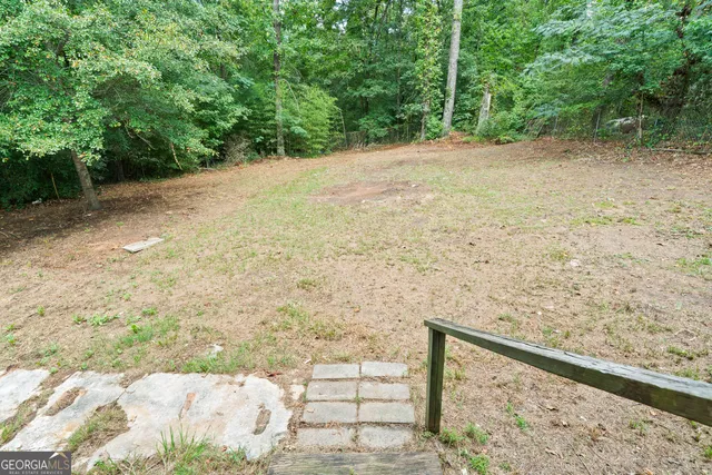 a view of a field with trees in the background