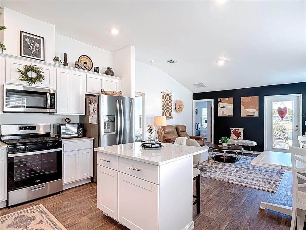 64 Bogey Place Bunnell, FL 32110 - Photo 11 of 55 a kitchen that has a lot of cabinets a sink and appliances in it