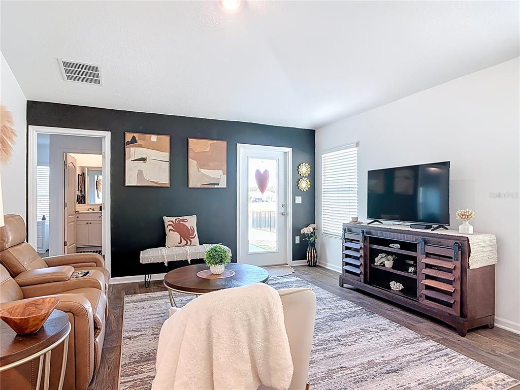 64 Bogey Place Bunnell, FL 32110 - Photo 17 of 55 a living room with furniture and a flat screen tv
