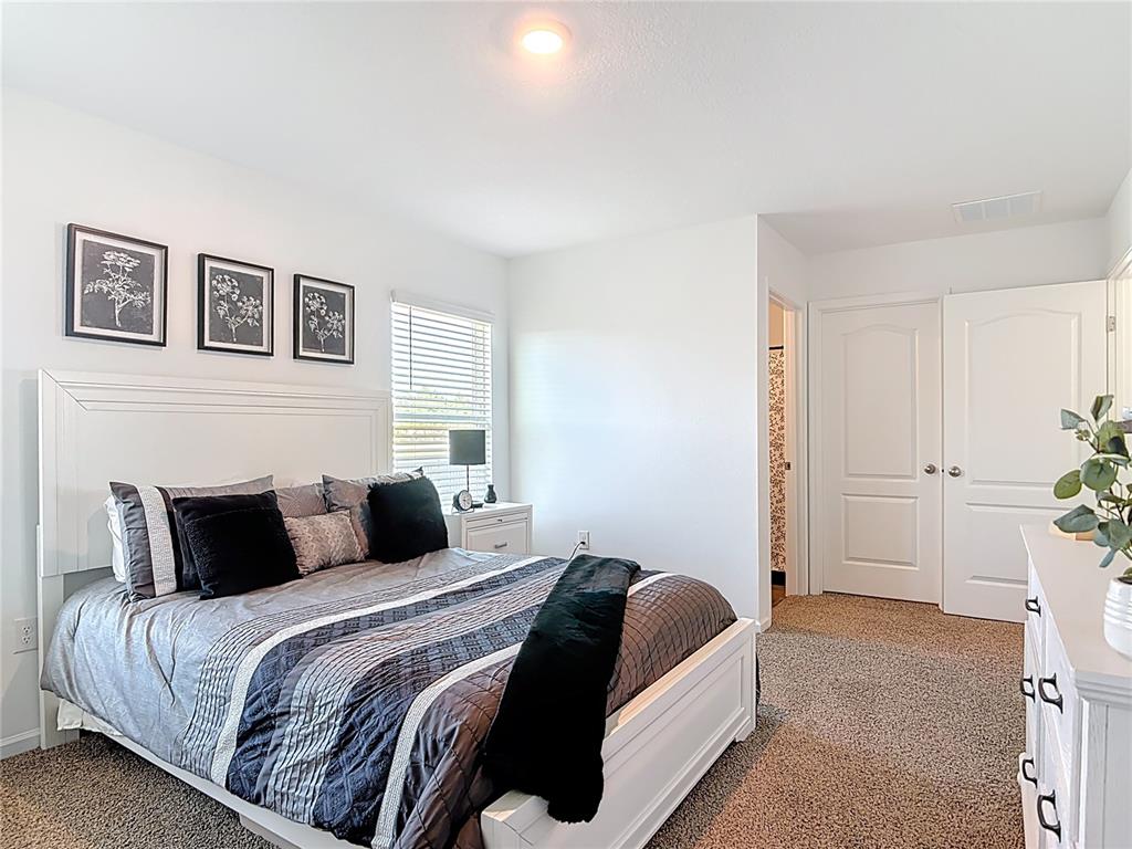 64 Bogey Place Bunnell, FL 32110 - Photo 18 of 55 a bedroom with a bed and a painting