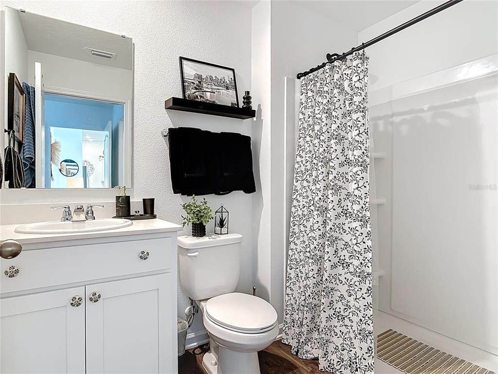 64 Bogey Place Bunnell, FL 32110 - Photo 20 of 55 a bathroom with a toilet sink a mirror and shower