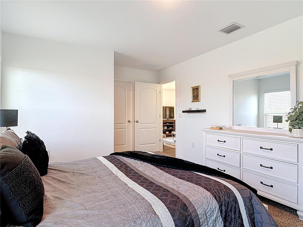 64 Bogey Place Bunnell, FL 32110 - Photo 21 of 55 a bedroom with a bed and a dresser