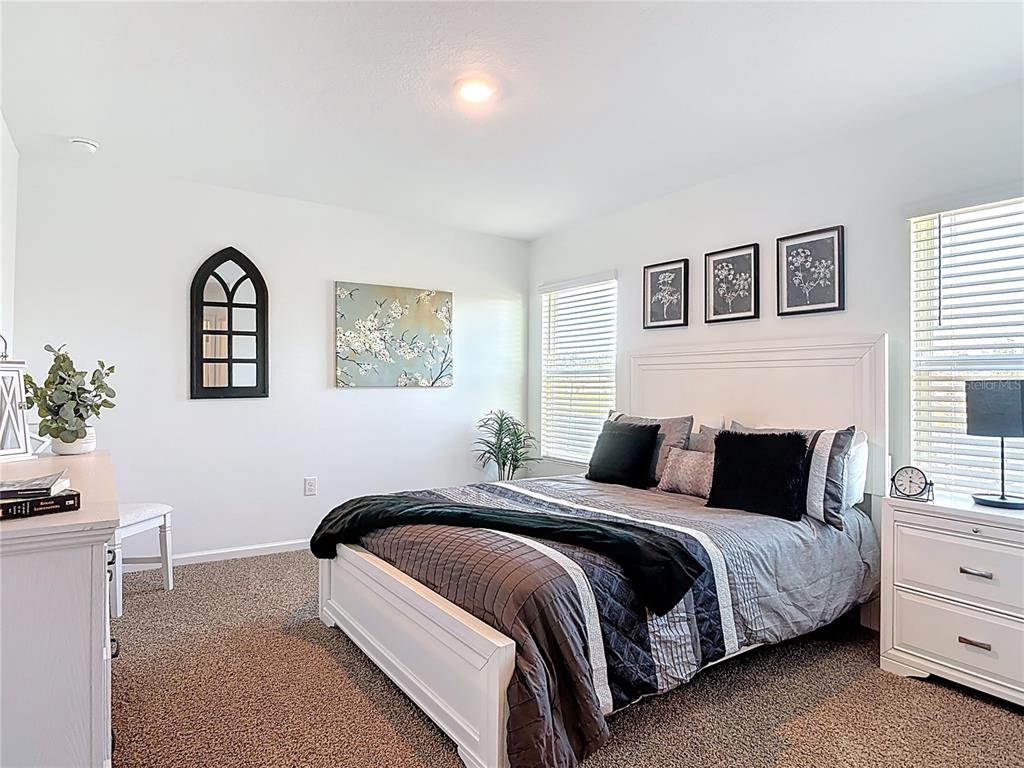 64 Bogey Place Bunnell, FL 32110 - Photo 22 of 55 a bedroom with a bed lamp and a window