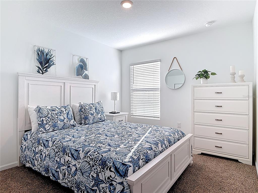 64 Bogey Place Bunnell, FL 32110 - Photo 28 of 55 a bedroom with a large bed and a window