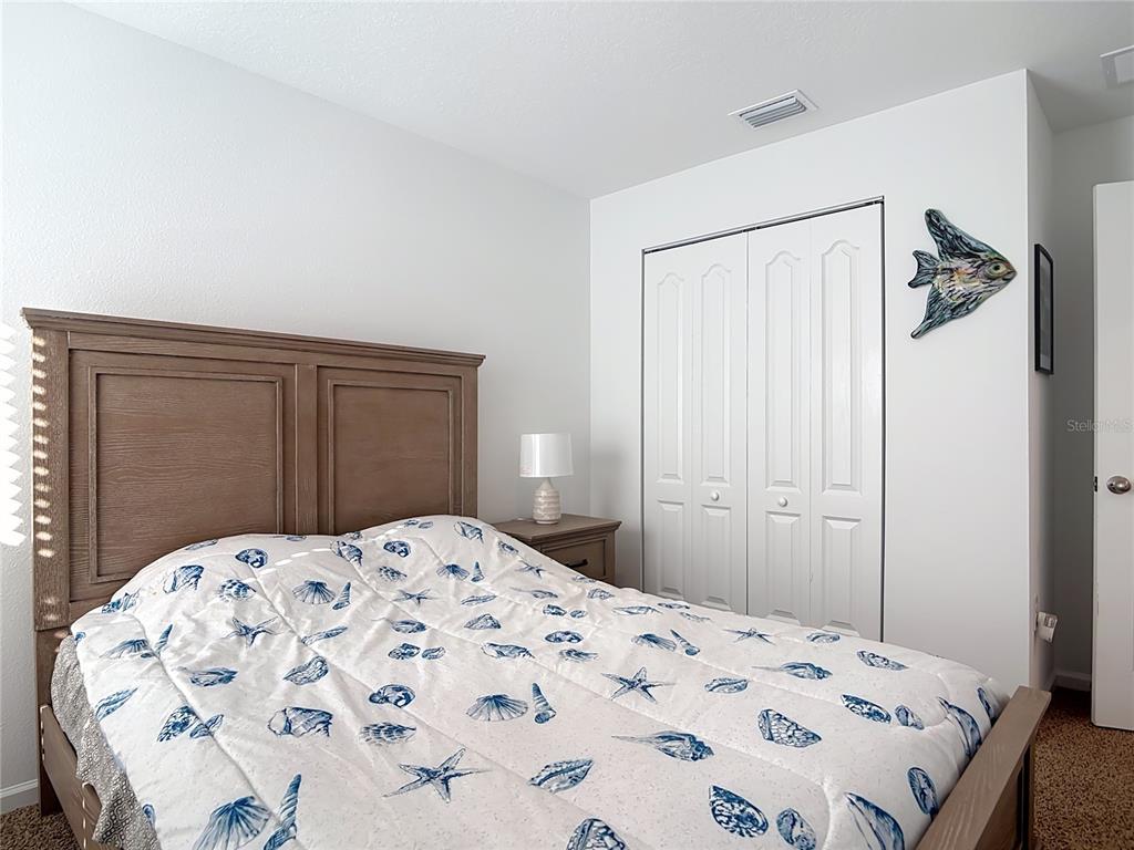 64 Bogey Place Bunnell, FL 32110 - Photo 29 of 55 a bedroom with a bed and a dresser