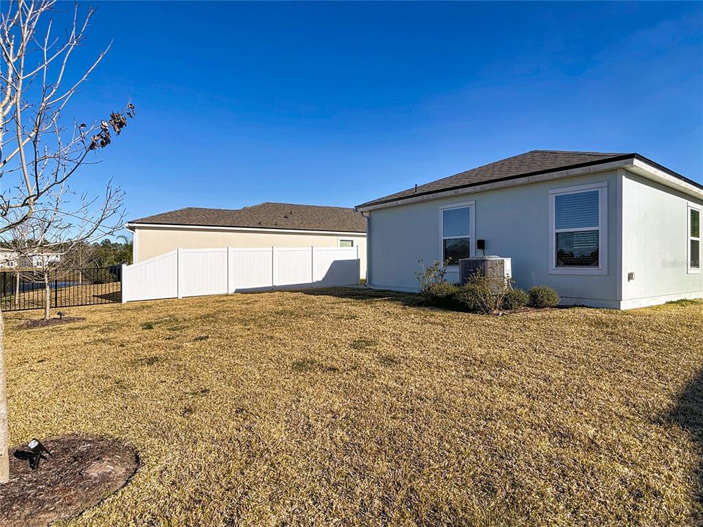 64 Bogey Place Bunnell, FL 32110 - Photo 45 of 55 a front view of a house with a yard and garage