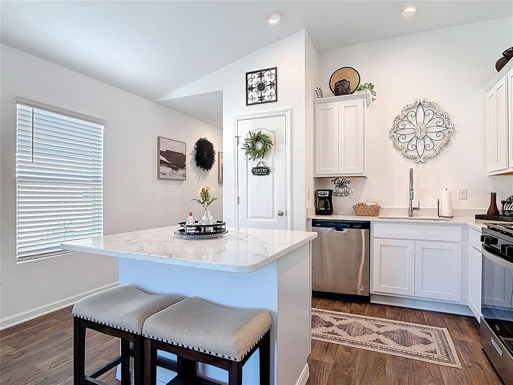 64 Bogey Place Bunnell, FL 32110 - Photo 7 of 55 a kitchen with a table and chairs in it