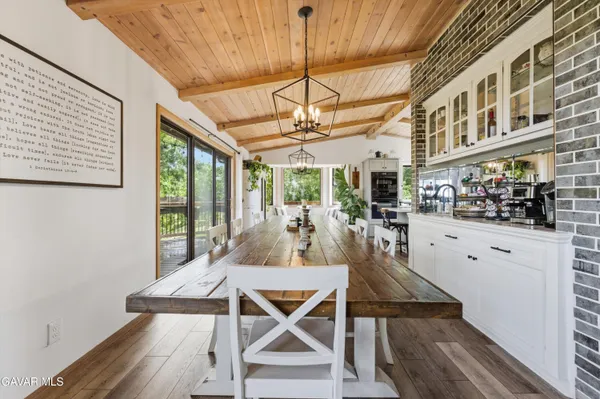 a view of a dining room with furniture wooden floor and chandelier