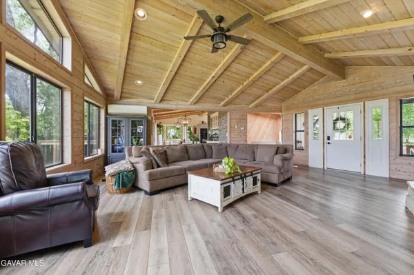 a living room with furniture and wooden floors