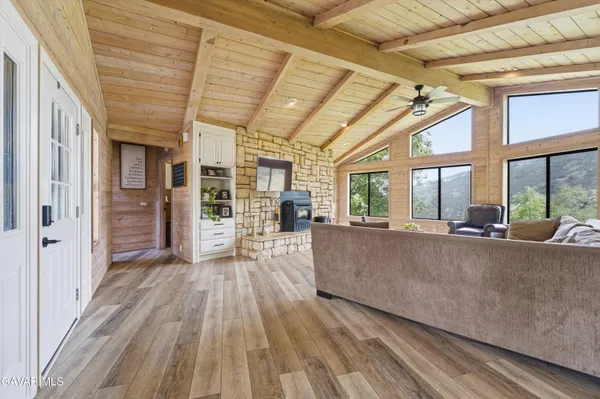 a living room with furniture and large windows