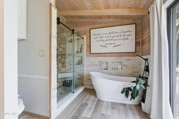 a bathroom with a bathtub and shower