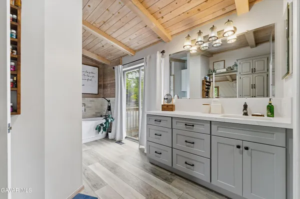 a spacious bathroom with a double vanity sink and a mirror