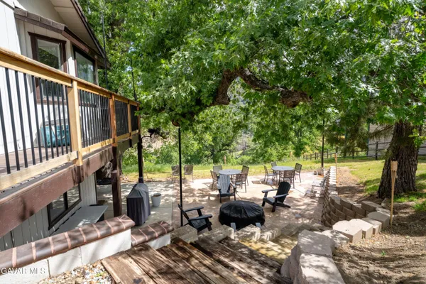 a view of a house with a large tree