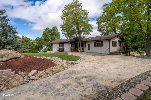 a front view of house with yard and seating area