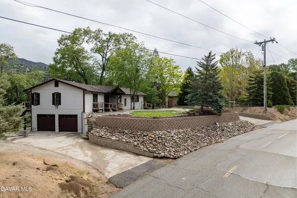 an aerial view of a house with a yard basket ball court and outdoor seating