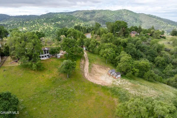 an aerial view of a house with yard swimming pool and lake view
