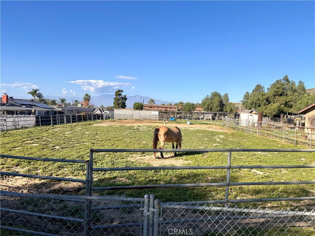 0 Daugherty Road Norco, CA 92860 - Photo 2 of 3 a view of a swimming pool with a lawn chairs under an umbrella
