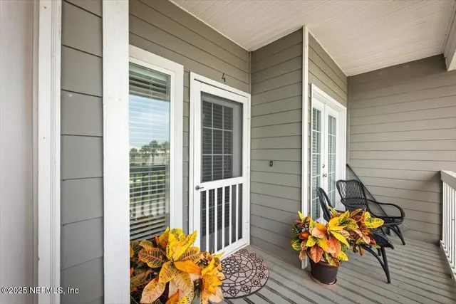 a view of a porch with furniture and garden