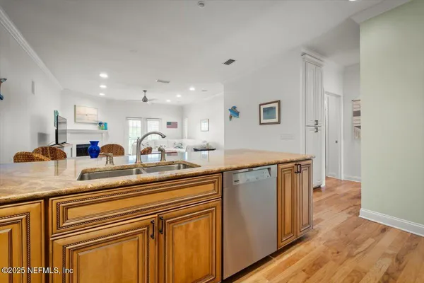 a kitchen with stainless steel appliances granite countertop a sink and wooden cabinets