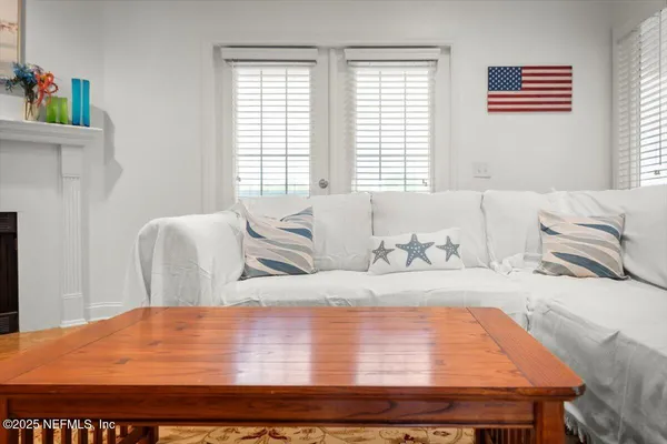 a living room with furniture and large window