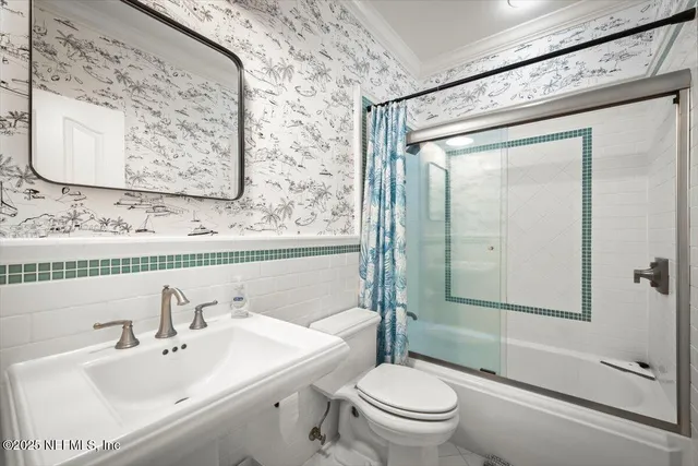 a bathroom with a double vanity sink toilet mirror and shower
