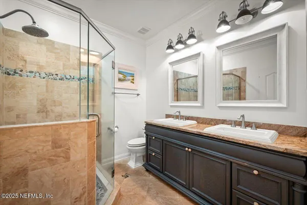 a bedroom with a bed a flat screen tv and a large window