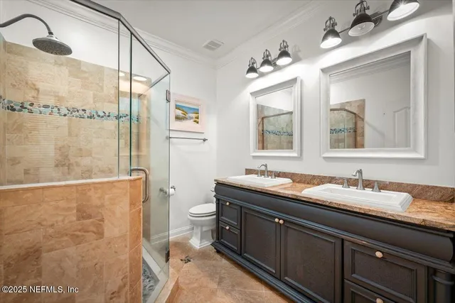 a bedroom with a bed a flat screen tv and a large window