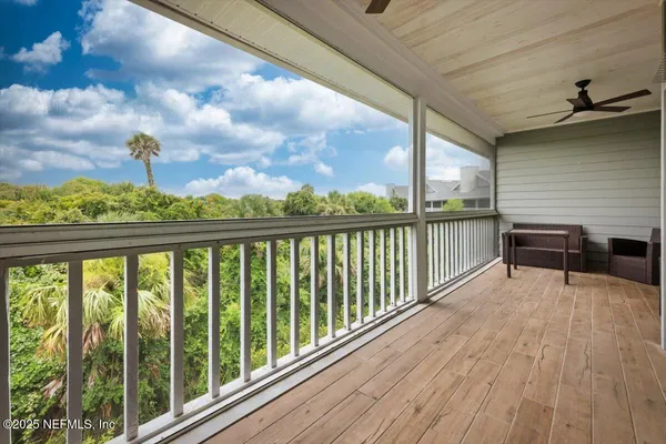 a view of a deck with table and chairs and wooden floor