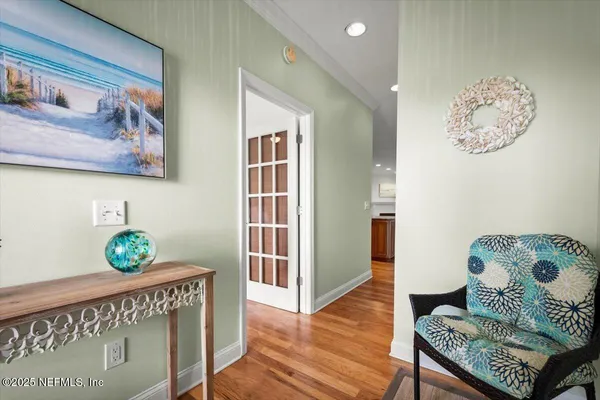 a hallway with furniture and wooden floor