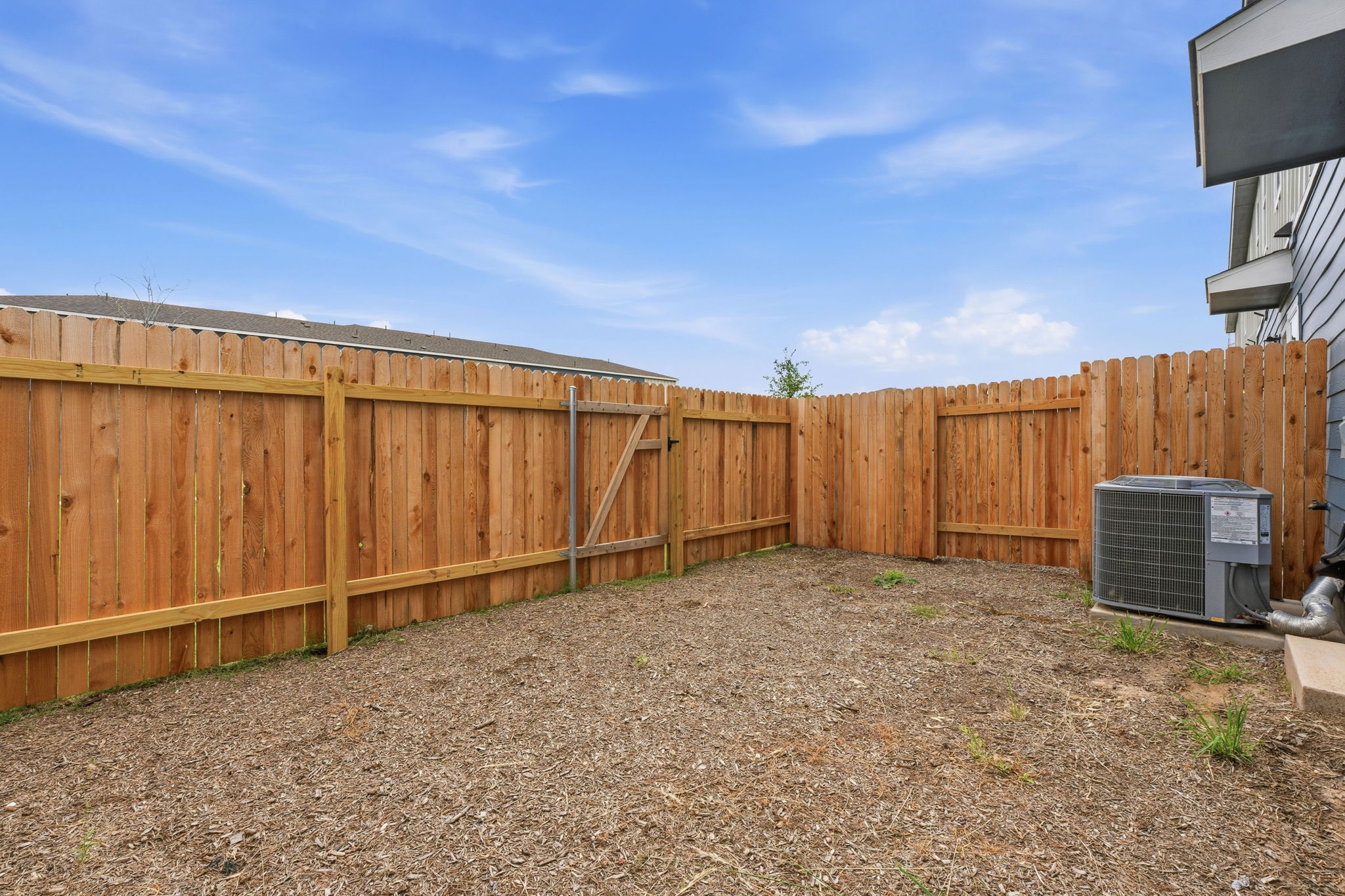 164 Cinnabar Lane, Unit 5 Kyle, TX 78640 - Photo 20 of 21 Private backyard with wood fencing and an exterior HVAC unit
