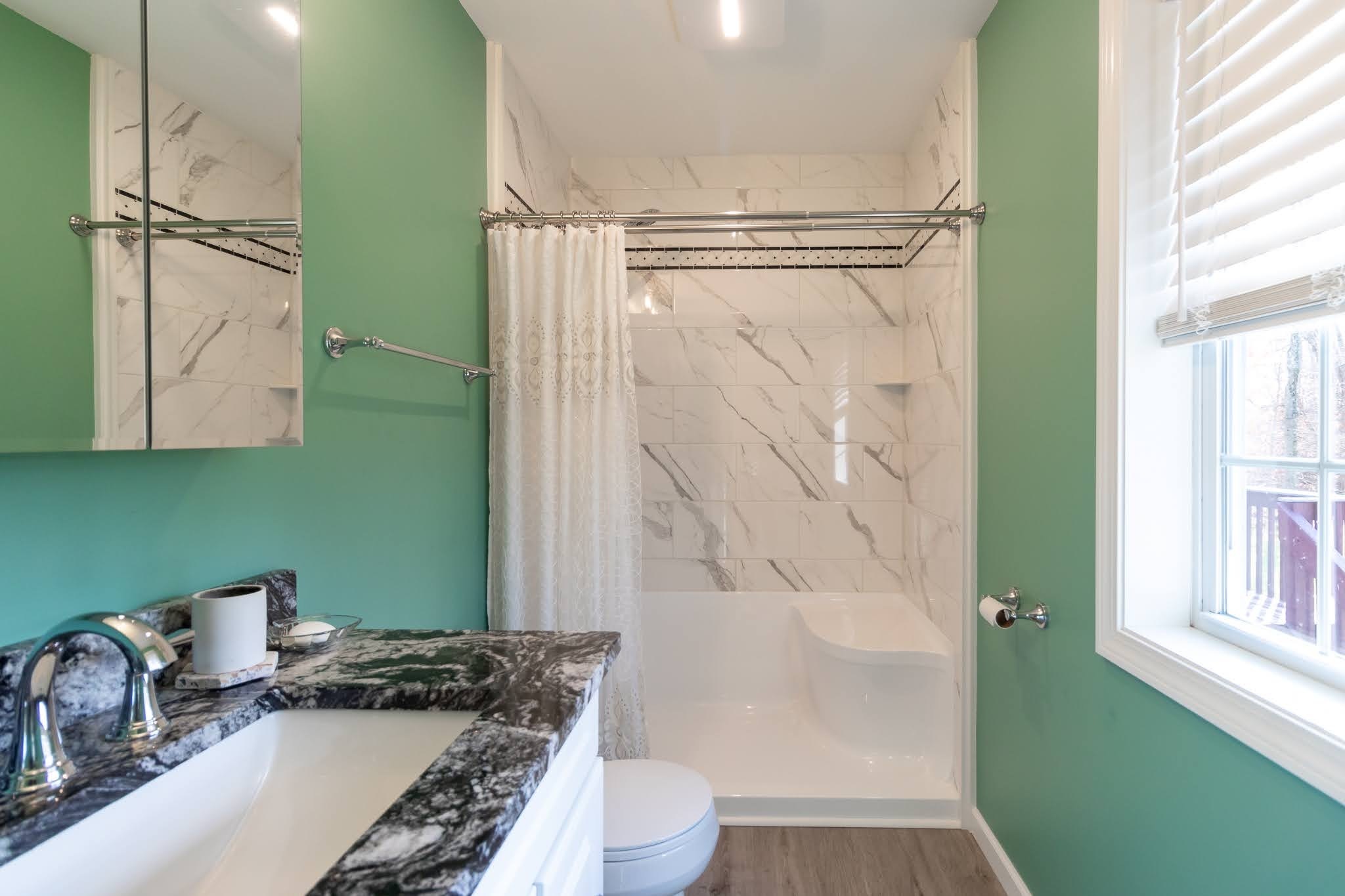 1001 Suffield Street Suffield, CT 06078 - Photo 16 of 36 a bathroom with a granite countertop sink a toilet and shower