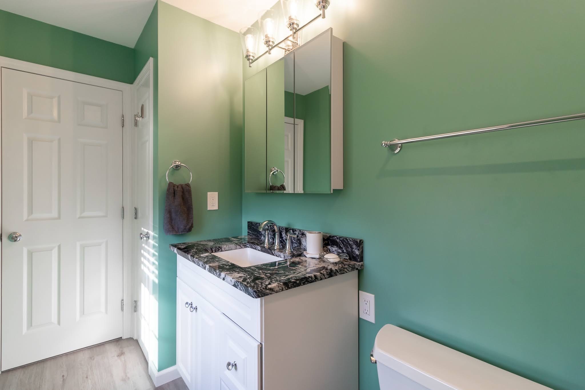 1001 Suffield Street Suffield, CT 06078 - Photo 17 of 36 a bathroom with a sink and a mirror