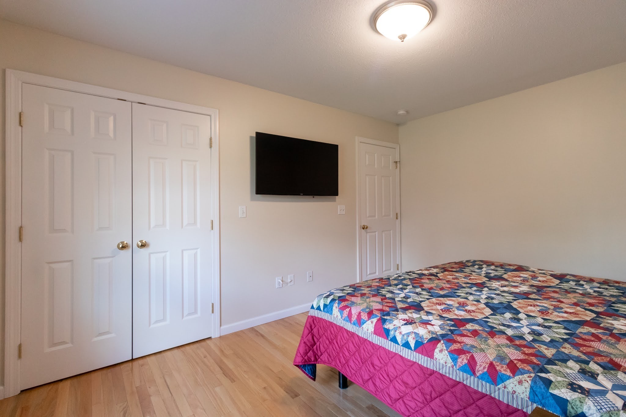 1001 Suffield Street Suffield, CT 06078 - Photo 19 of 36 a bedroom with a bed and a flat screen tv