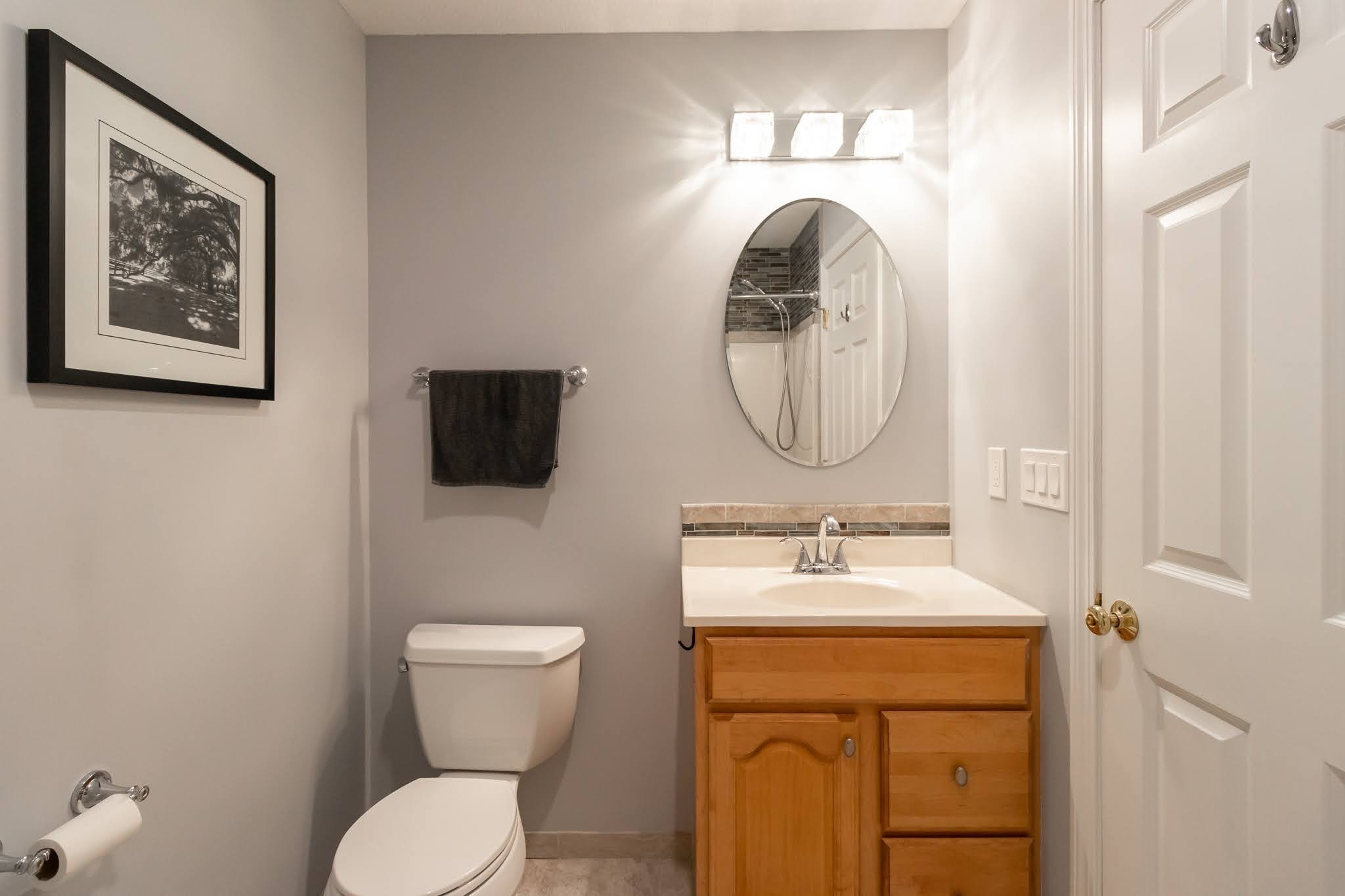 1001 Suffield Street Suffield, CT 06078 - Photo 20 of 36 a bathroom with a toilet sink and mirror
