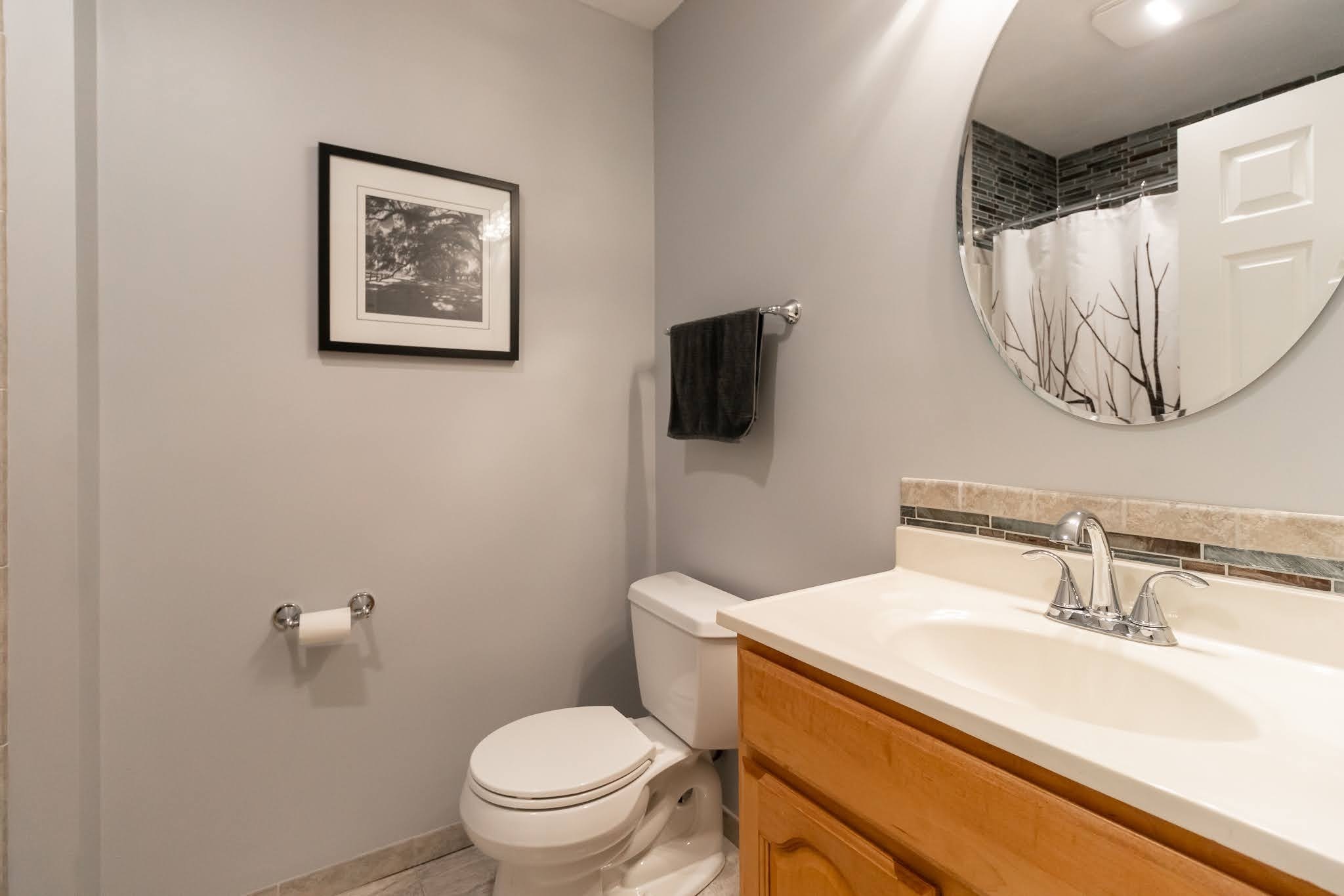 1001 Suffield Street Suffield, CT 06078 - Photo 22 of 36 a bathroom with a toilet sink and mirror