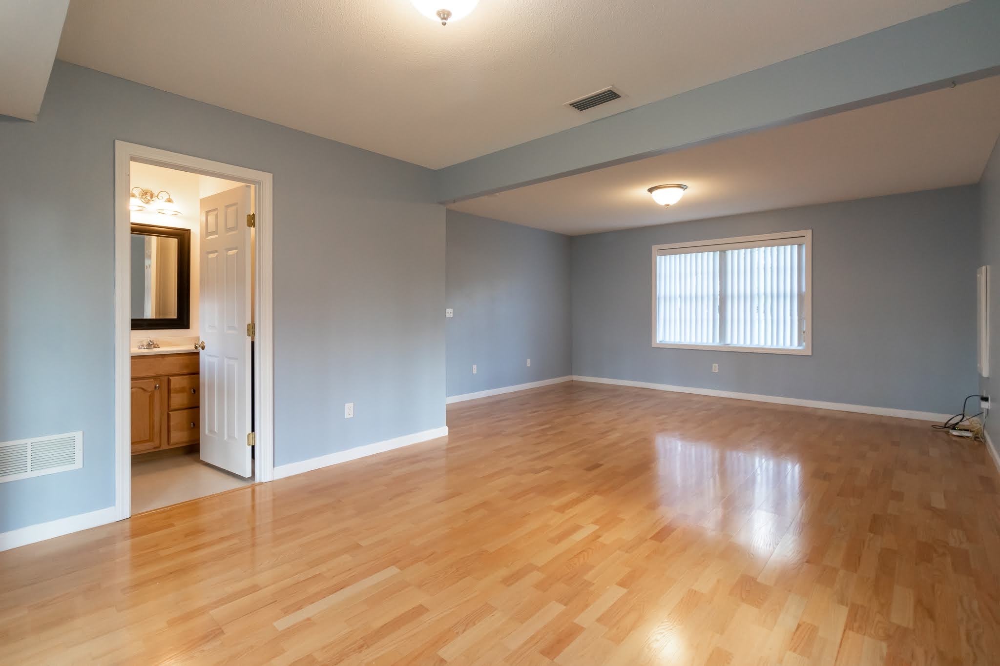 1001 Suffield Street Suffield, CT 06078 - Photo 30 of 36 an empty room with wooden floor and windows