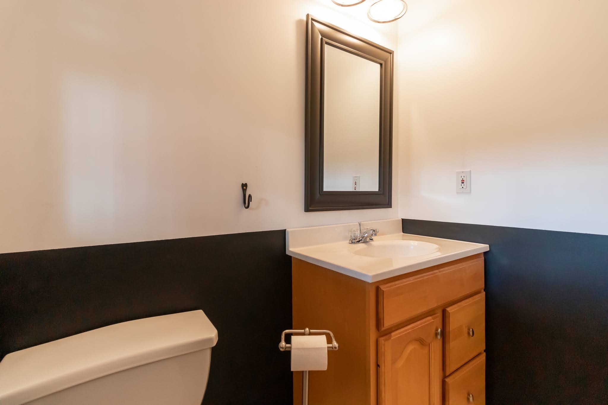 1001 Suffield Street Suffield, CT 06078 - Photo 31 of 36 a bathroom with a sink a toilet and mirror