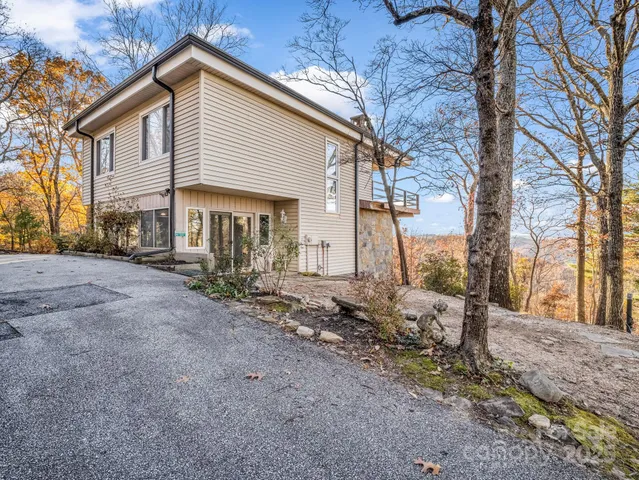 a view of a house with a yard covered in snow
