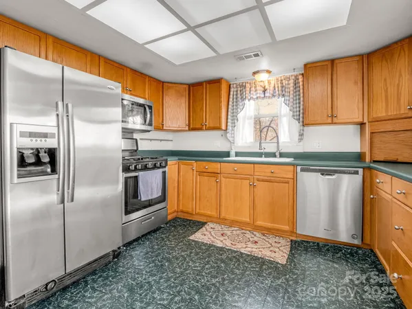 a bedroom with a bed a lamp and window