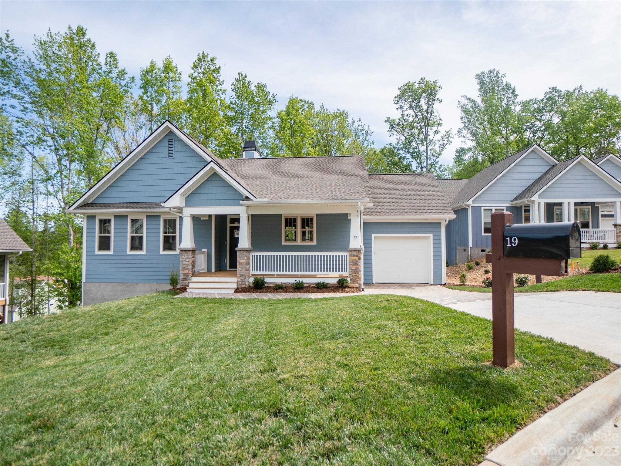 19 Ivestor Gap Road, Unit 1177 Biltmore Lake, NC 28715 - Photo 1 of 15 a front view of a house with a garden and trees