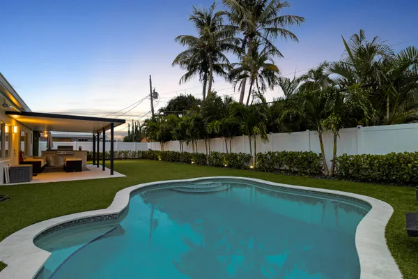 a view of a swimming pool with a table and chairs
