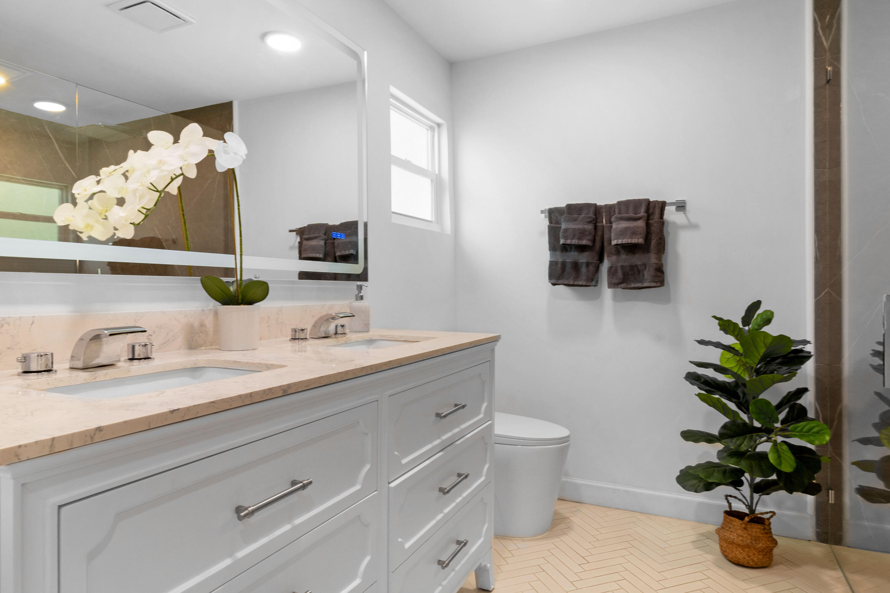 2862 Northeast 35th Court Lighthouse Point, FL 33064 - Photo 18 of 42 a bathroom with a potted plant on the counter and mirror